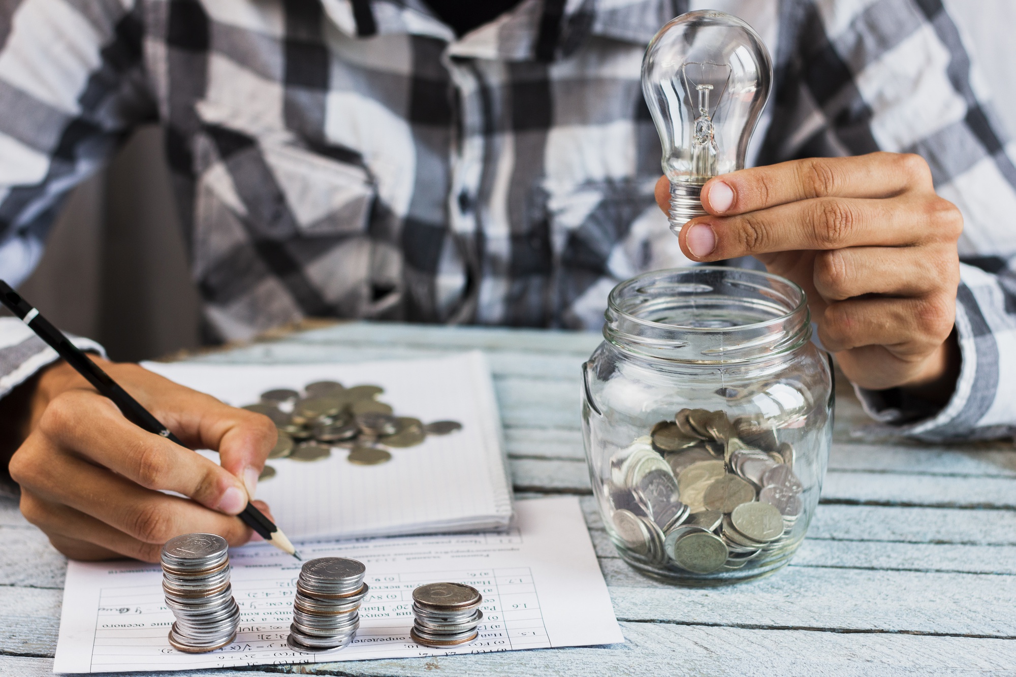 high-angle-man-calculating-savings